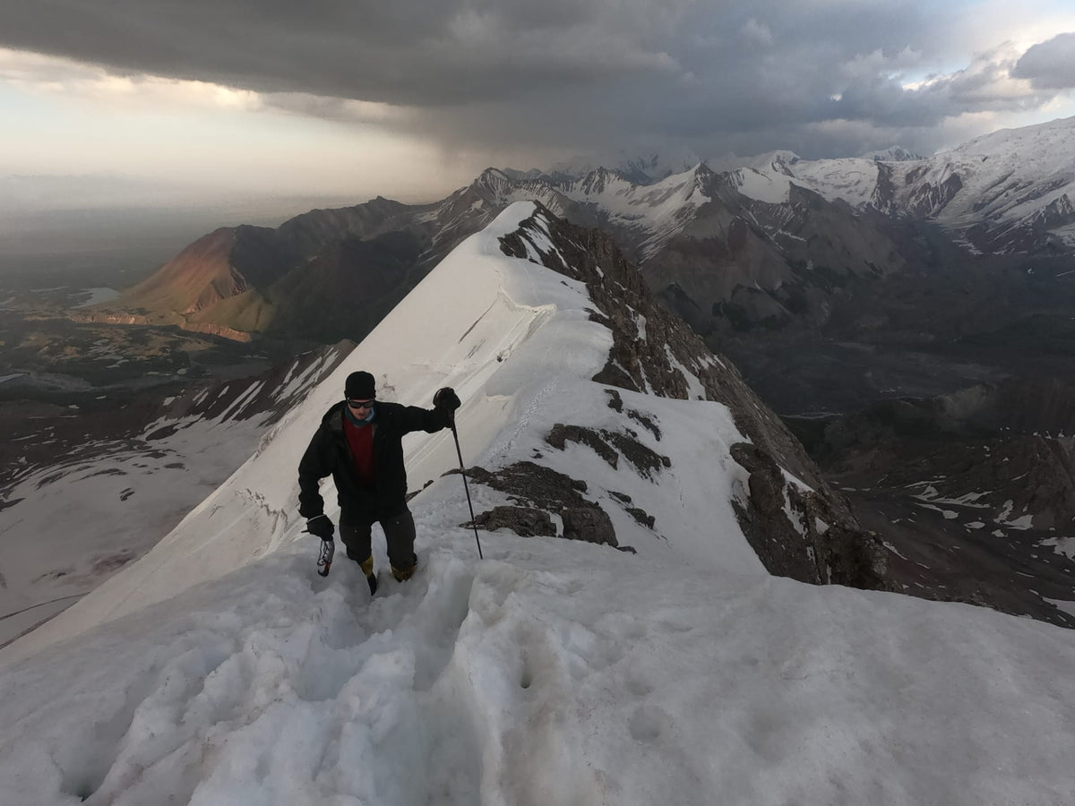 Ambassador Trevor hiking, nearing the top of Pik Pretrovsky