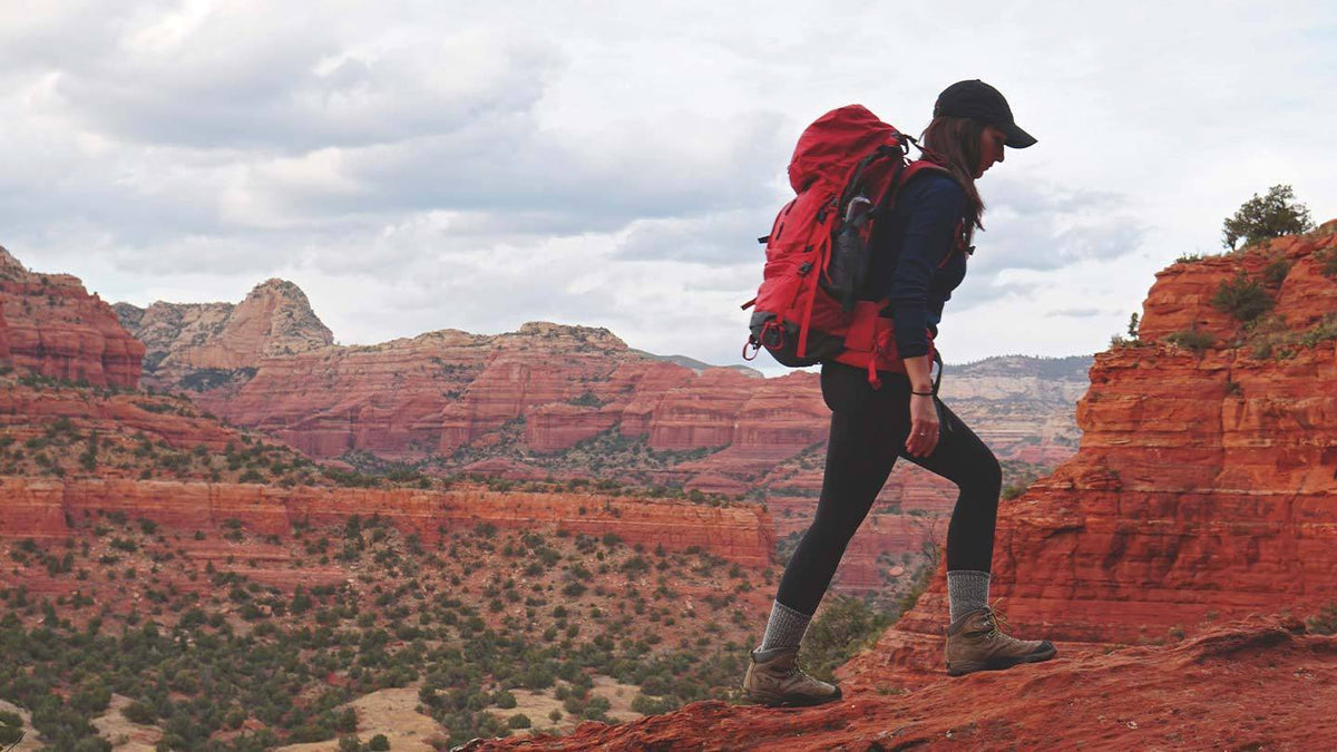 woman hiking in arizona while wearing minus33 merino wool midweight 1/4 zip mid layer shirt