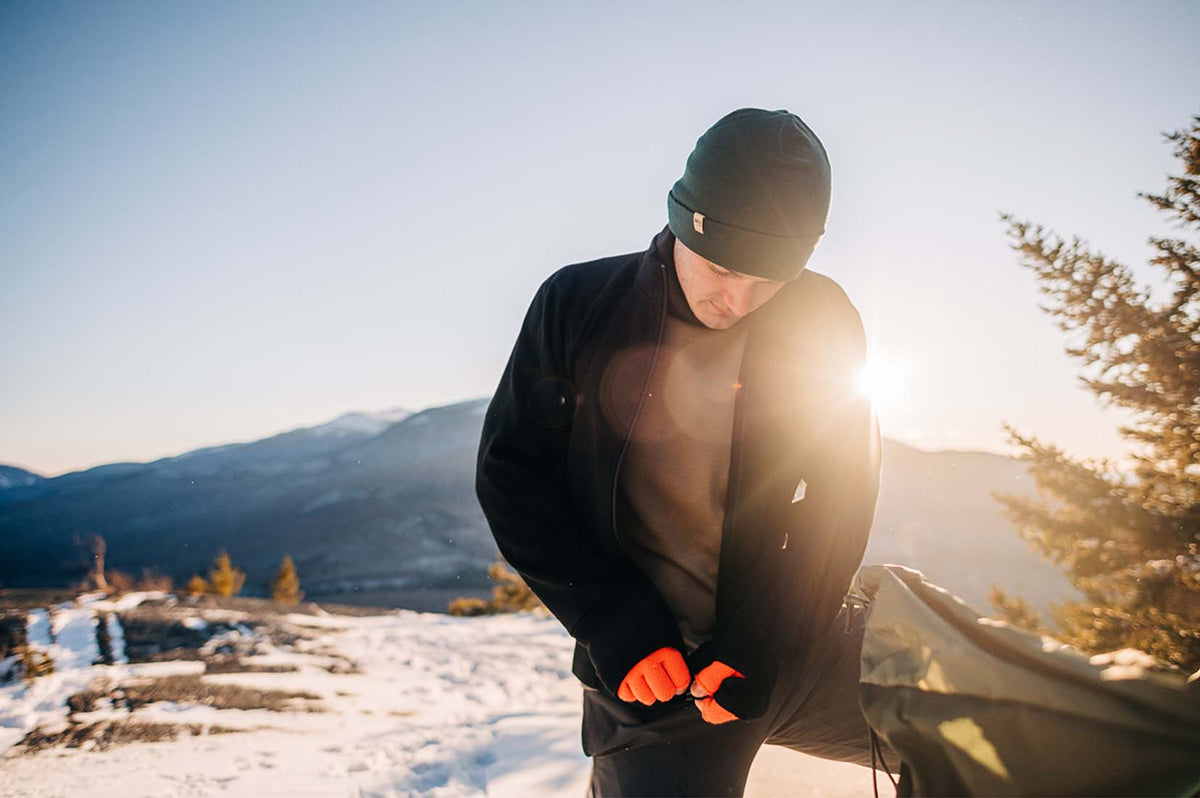 man wearing minus33 merino wool midweight crew shirt and beanie