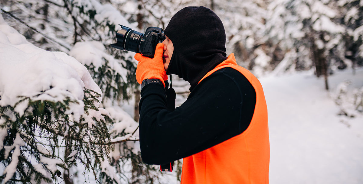man taking photos wearing an expedition weight vest