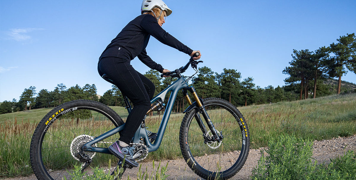 woman biking wearing midweight leggings