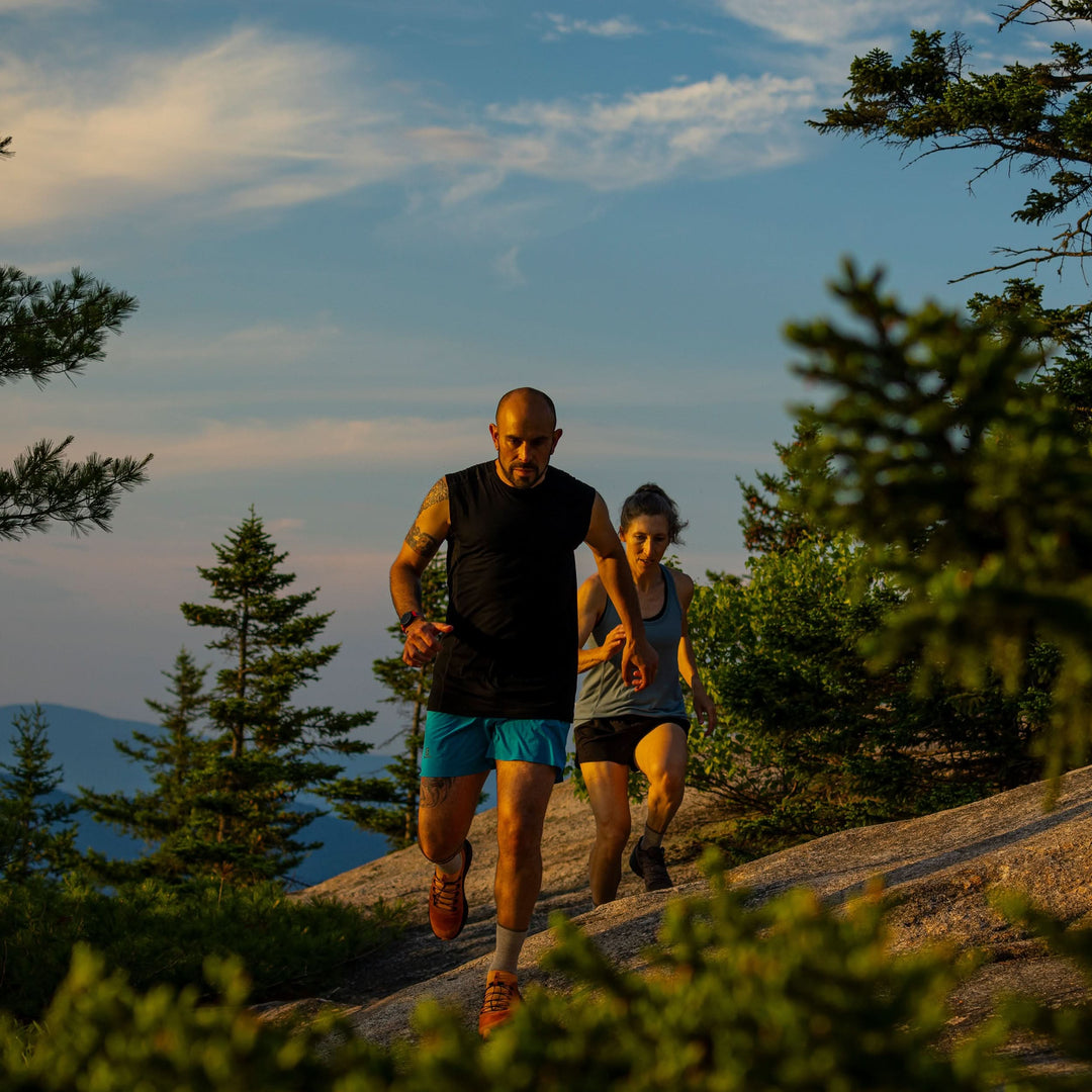 Couple running through the mountain white mountains new hampshire base layer merino wool minus33 tank top shorts breathable socks 