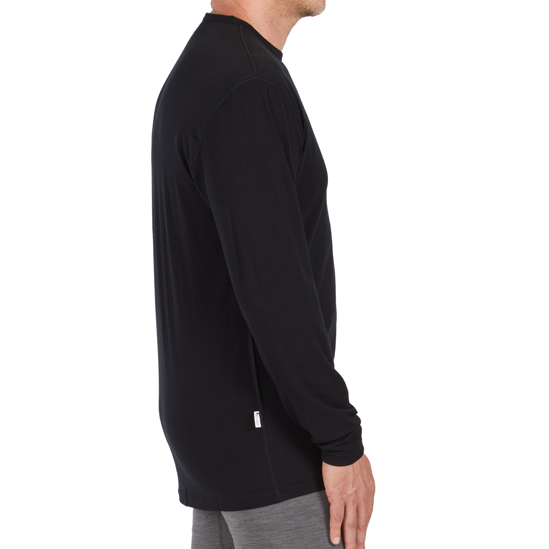 A man models the microweight long sleeved merino wool base layer crew neck top, side view 
