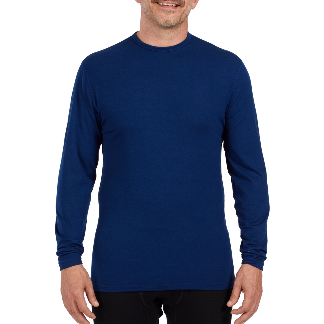 A man models the microweight long sleeved merino wool base layer crew neck top #color_navy