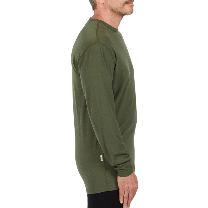 A man models the microweight long sleeved merino wool base layer crew neck top, side view 