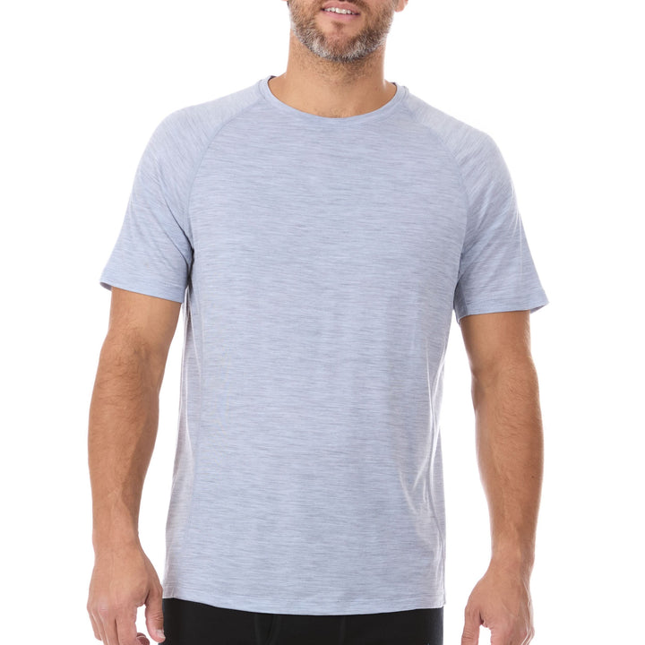 A man models the microweight Merino wool t shirt, your perfect choice for hitting the gym or setting foot on the trails. Raglan sleeves and side panels create a garment that moves with you 