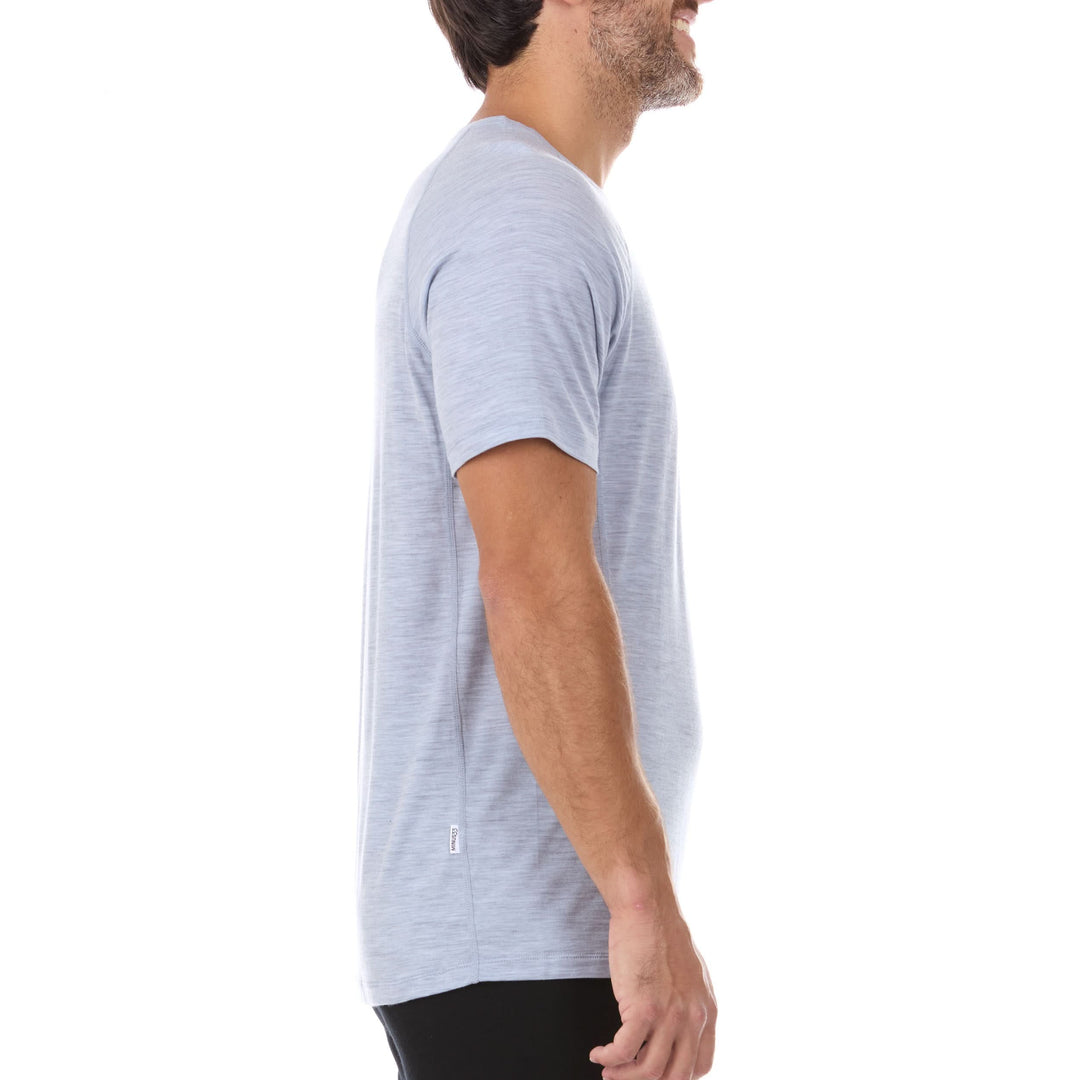 A man models the microweight Merino wool t shirt your perfect choice for hitting the gym or setting foot on the trails. Raglan sleeves and side panels create a garment that moves with you 
