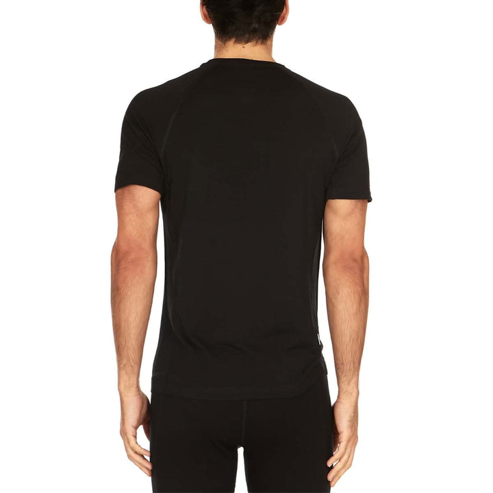 A man models the microweight Merino wool t shirt, your perfect choice for hitting the gym or setting foot on the trails. Raglan sleeves and side panels create a garment that moves with you 