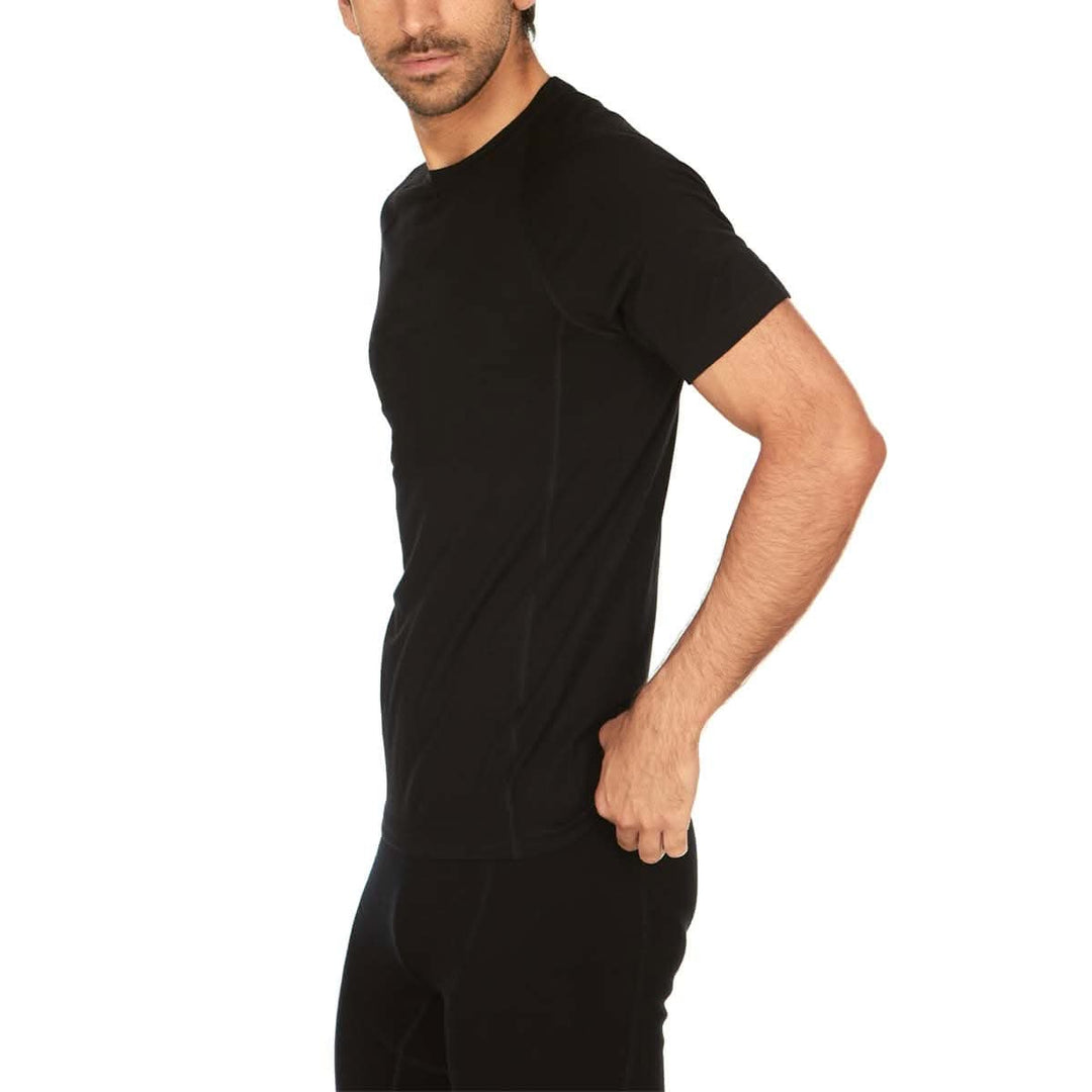 A man models the microweight Merino wool t shirt your perfect choice for hitting the gym or setting foot on the trails. Raglan sleeves and side panels create a garment that moves with you 