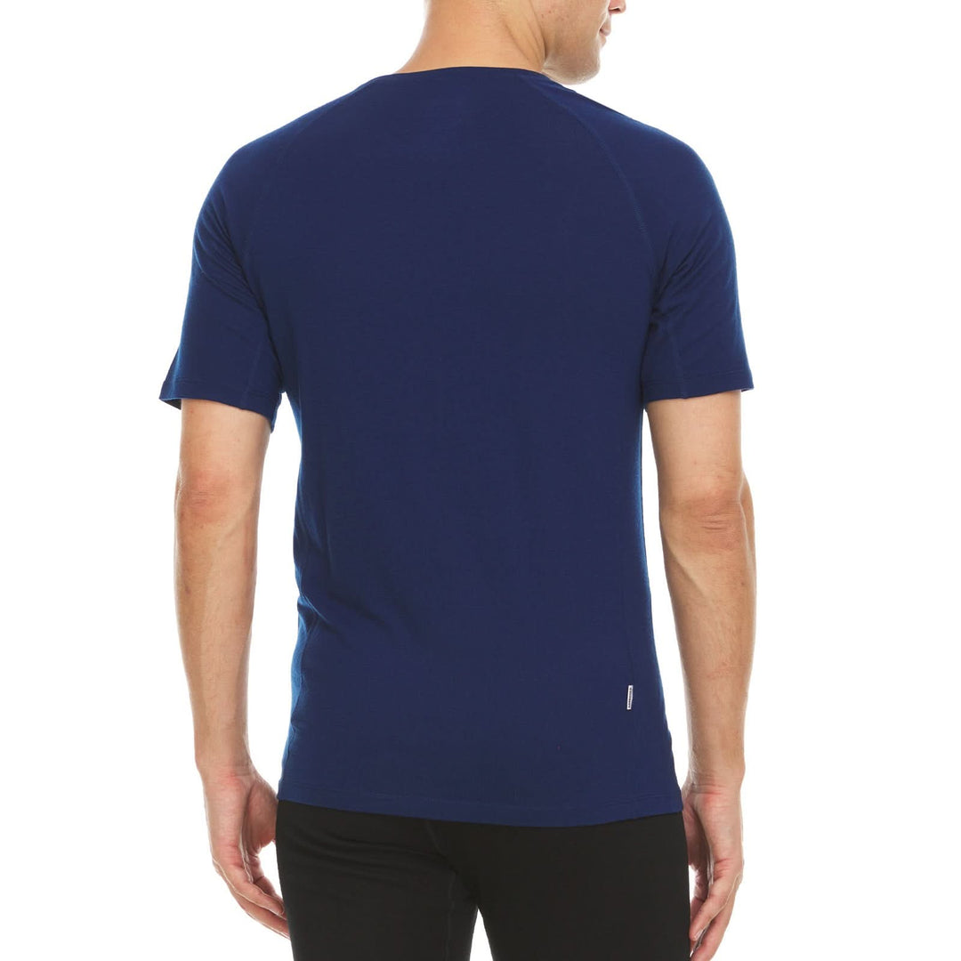 Back view of a male model wearing a navy microweight merino wool raglan T-shirt with side panels 
