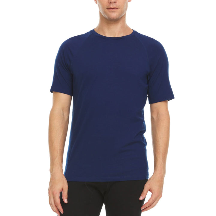 A man models the microweight Merino wool t shirt your perfect choice for hitting the gym or setting foot on the trails. Raglan sleeves and side panels create a garment that moves with you 