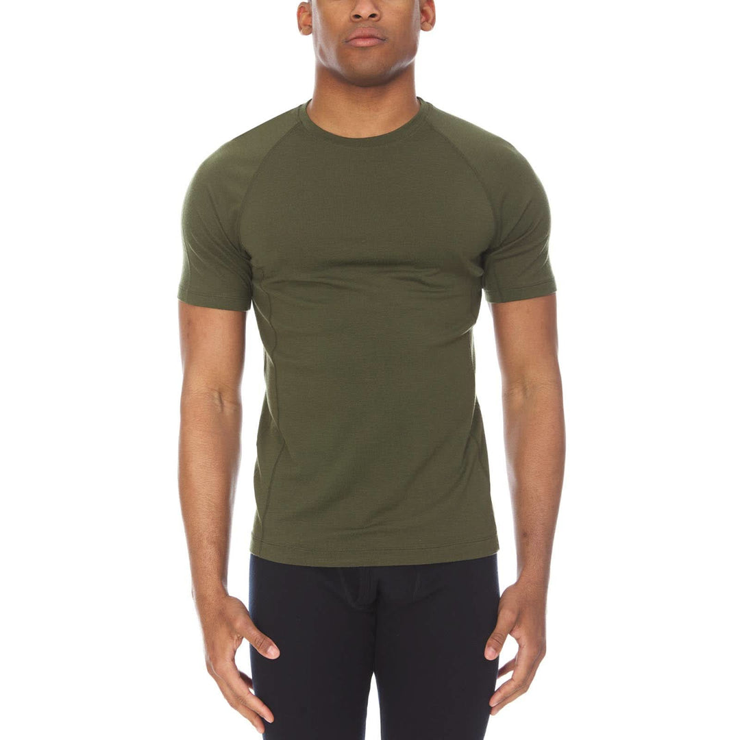 A man models the microweight merino wool t shirt, your perfect choice for hitting the gym or setting foot on the trails. Raglan sleeves and side panels create a garment that moves with you 