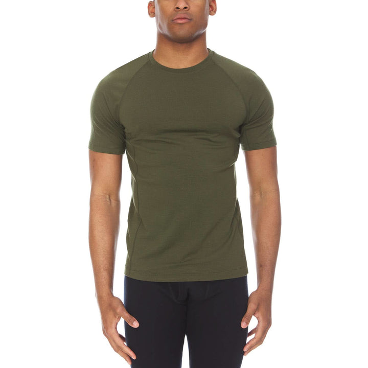 A man models the microweight merino wool t shirt, your perfect choice for hitting the gym or setting foot on the trails. Raglan sleeves and side panels create a garment that moves with you 