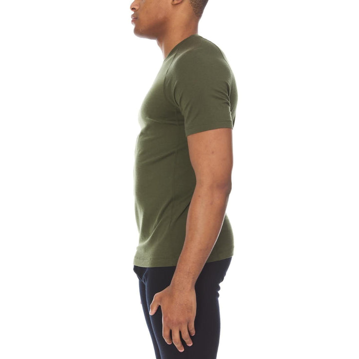A man models the microweight merino wool t shirt, your perfect choice for hitting the gym or setting foot on the trails. Raglan sleeves and side panels create a garment that moves with you 