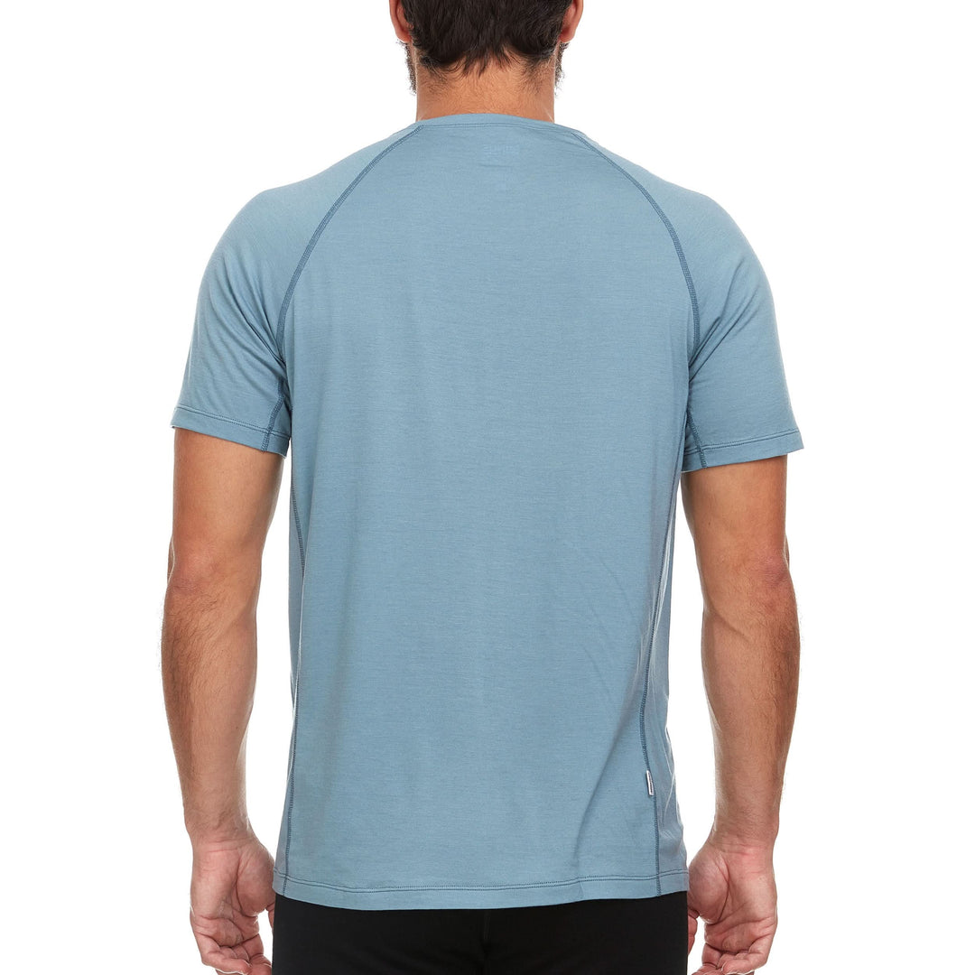 A man models the microweight Merino wool t shirt your perfect choice for hitting the gym or setting foot on the trails. Raglan sleeves and side panels create a garment that moves with you 