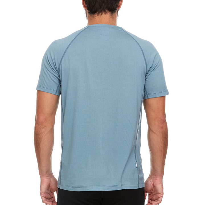 A man models the microweight Merino wool t shirt your perfect choice for hitting the gym or setting foot on the trails. Raglan sleeves and side panels create a garment that moves with you 