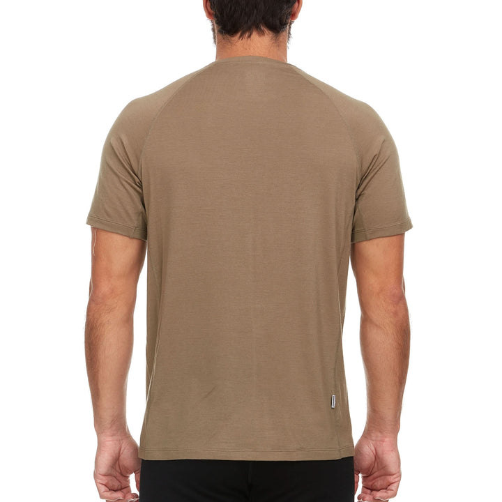 A man models the microweight Merino wool t shirt, your perfect choice for hitting the gym or setting foot on the trails. Raglan sleeves and side panels create a garment that moves with you 