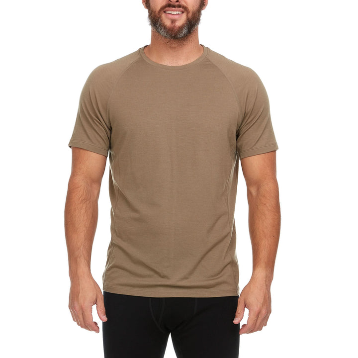 A man models the microweight Merino wool t shirt, your perfect choice for hitting the gym or setting foot on the trails. Raglan sleeves and side panels create a garment that moves with you 