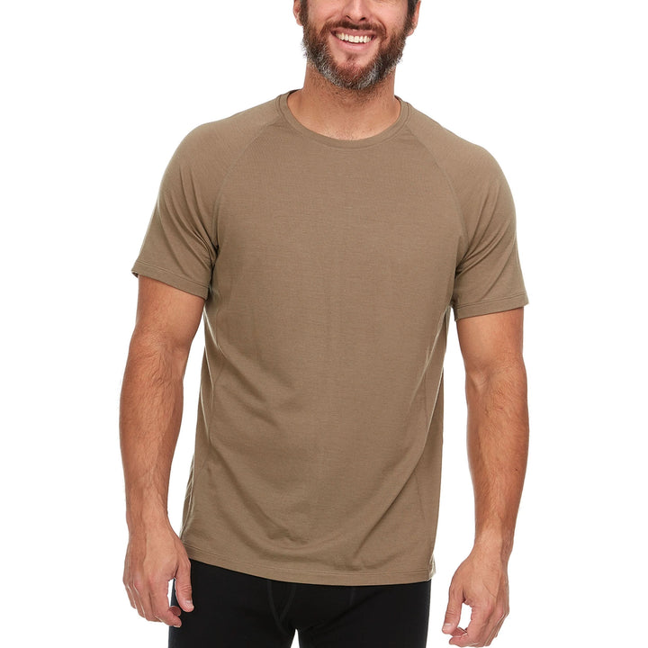 A man models the microweight Merino wool t shirt, your perfect choice for hitting the gym or setting foot on the trails. Raglan sleeves and side panels create a garment that moves with you 