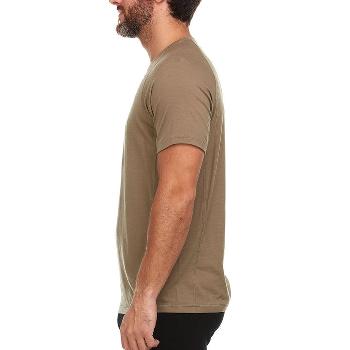 A man models the microweight Merino wool t shirt, your perfect choice for hitting the gym or setting foot on the trails. Raglan sleeves and side panels create a garment that moves with you 
