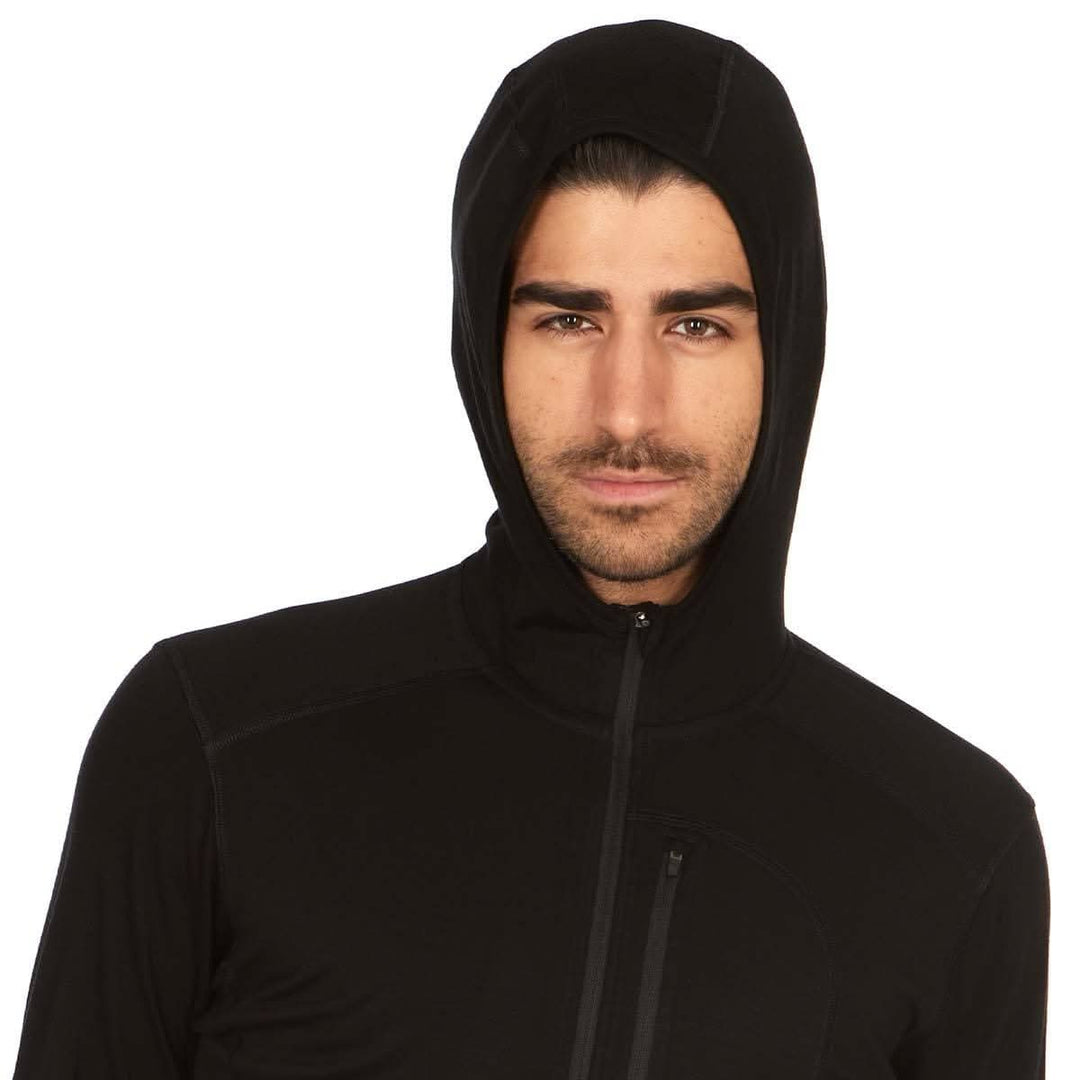 Front three-quarter hood-up view of a male model wearing a black microweight merino wool quarter-zip sun hoodie 