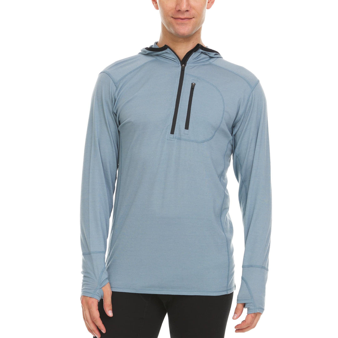 A man models a slate blue microweight merino wool quarter zip sun hoodie. 