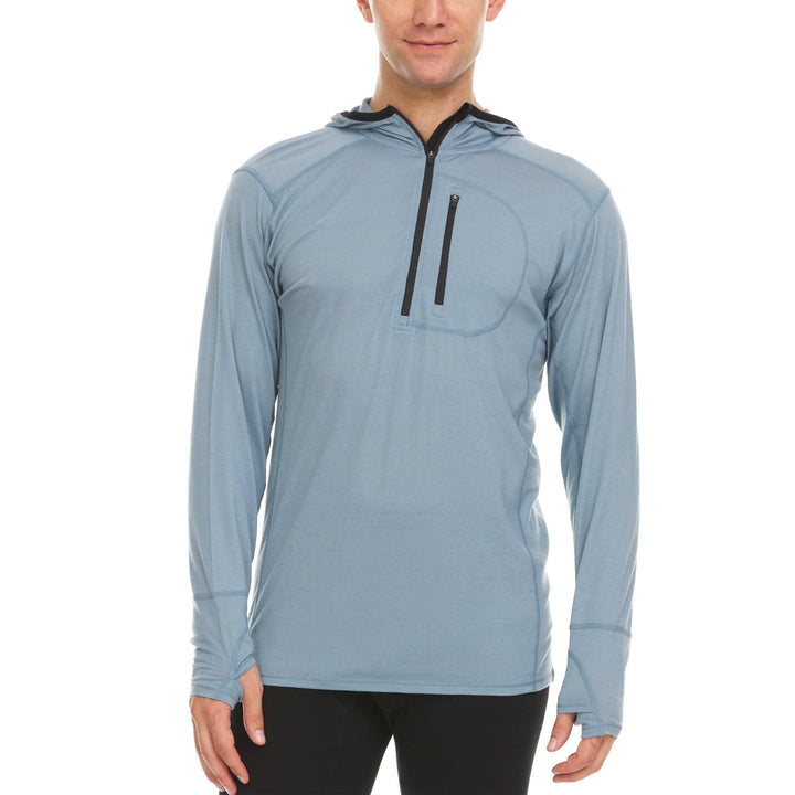 A man models a slate blue microweight merino wool quarter zip sun hoodie. 