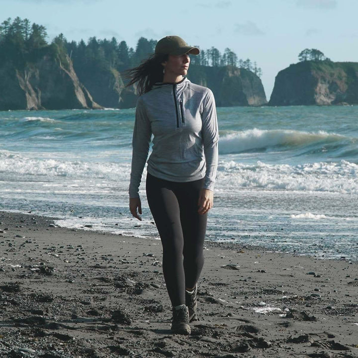 Womens super lightweight wool hoodie quarter zip merino wool outdoor top. Beach view. 