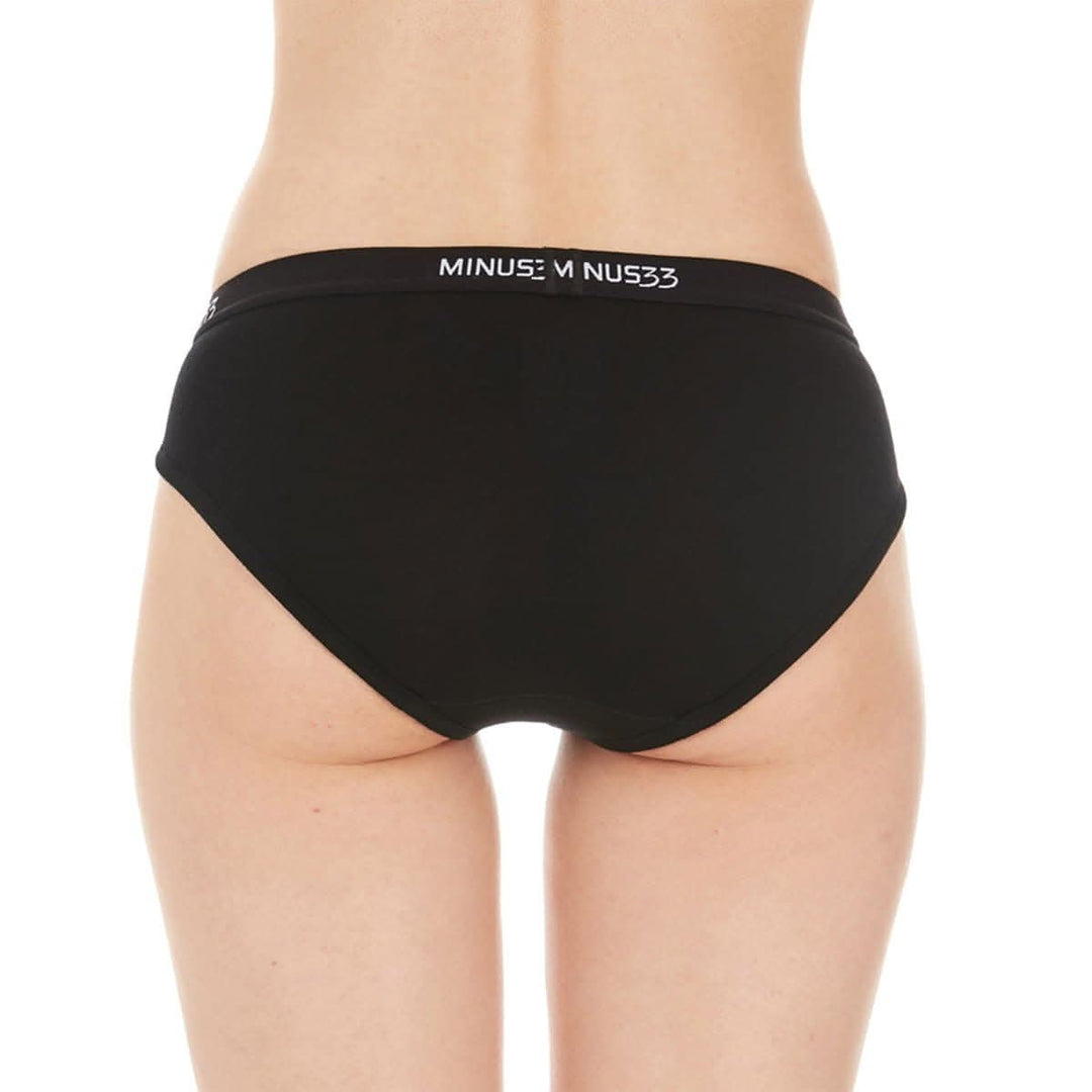 A woman models a pair of super soft merino wool bikini brief underwear. Light and breathable, these briefs feature a 1-inch woven sport elastic band, and high cut leg openings for a better range of movement. Back view. 