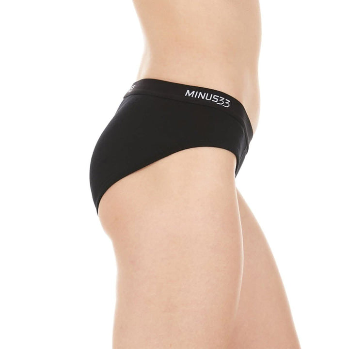 A woman models a pair of super soft merino wool bikini brief underwear. Light and breathable, these briefs feature a 1-inch woven sport elastic band, and high cut leg openings for a better range of movement. 