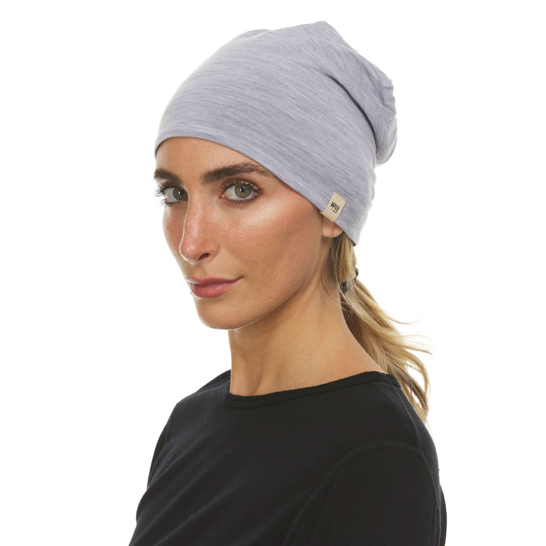 A man models the super lightweight reversible beanie. This merino wool blend beanie is slim enough to fit under a helmet, but warm enough to wear by itself on a chilly run.
