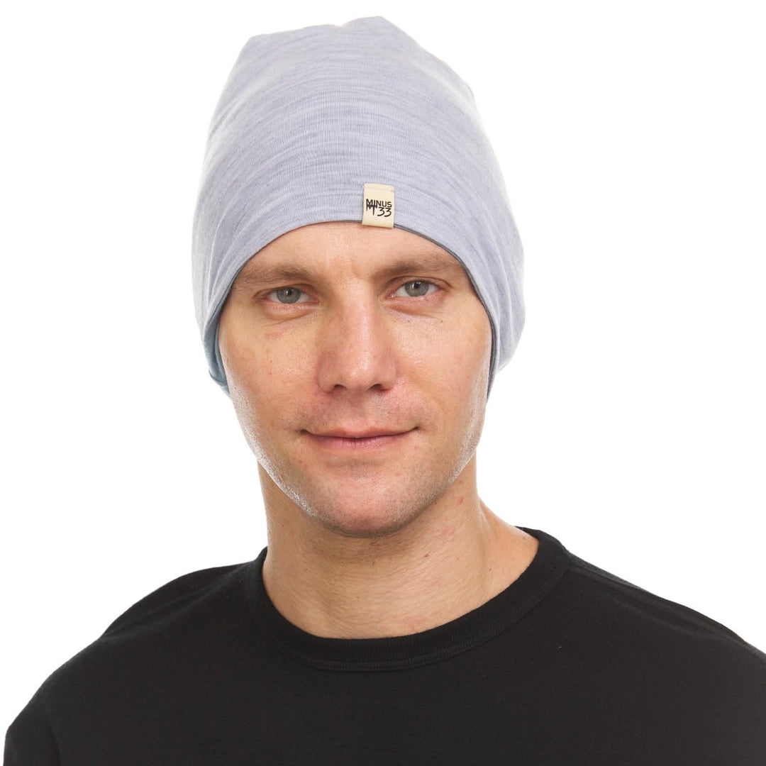 A man models the super lightweight reversible beanie. This merino wool blend beanie is slim enough to fit under a helmet, but warm enough to wear by itself on a chilly run.
