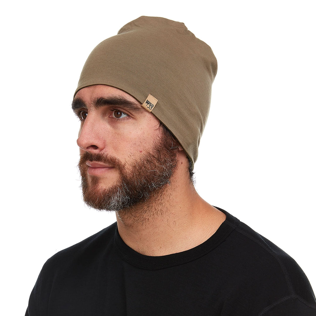 A man models the super lightweight reversible beanie. This merino wool blend beanie is slim enough to fit under a helmet, but warm enough to wear by itself on a chilly run.
