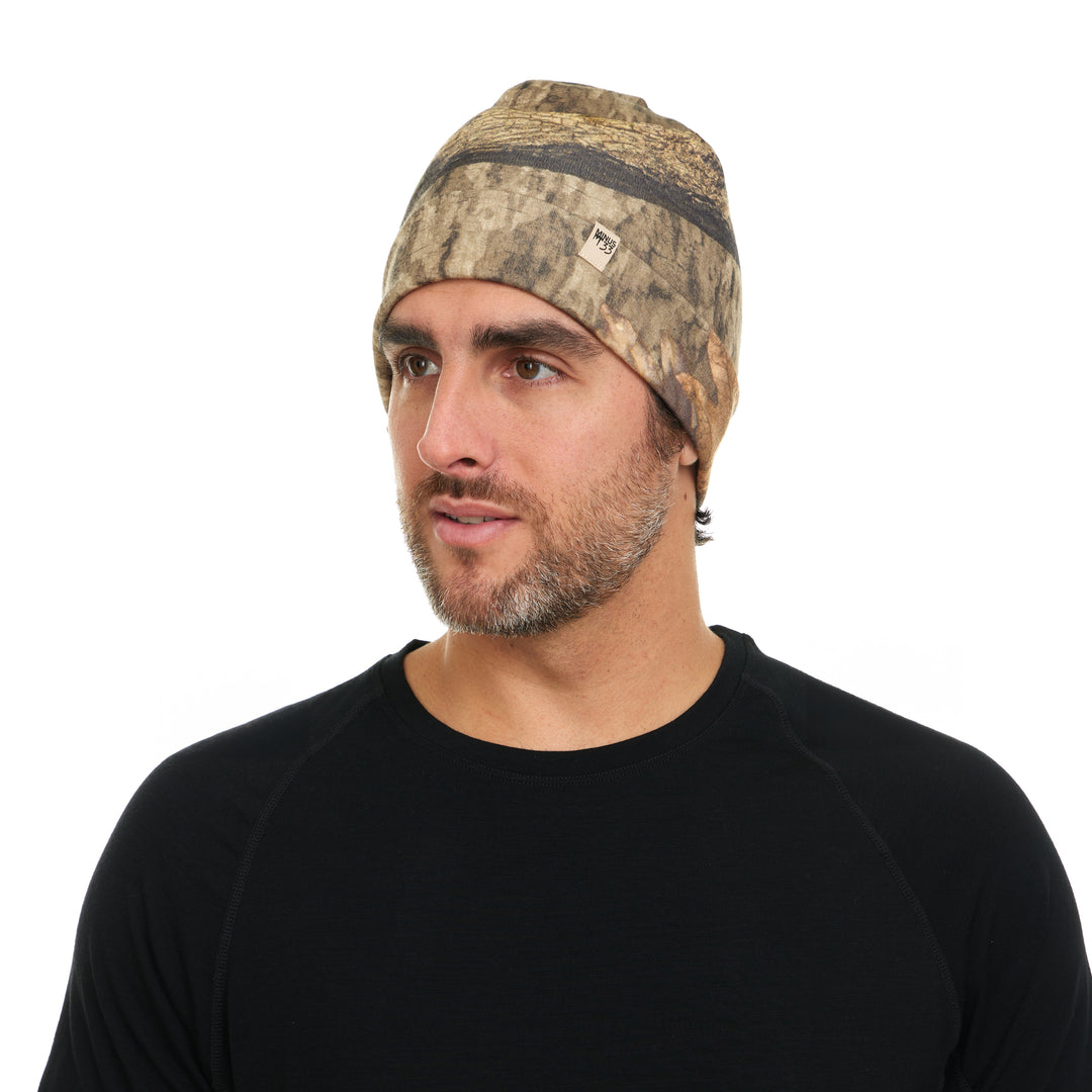 Man wearing a camouflage beanie on a white background