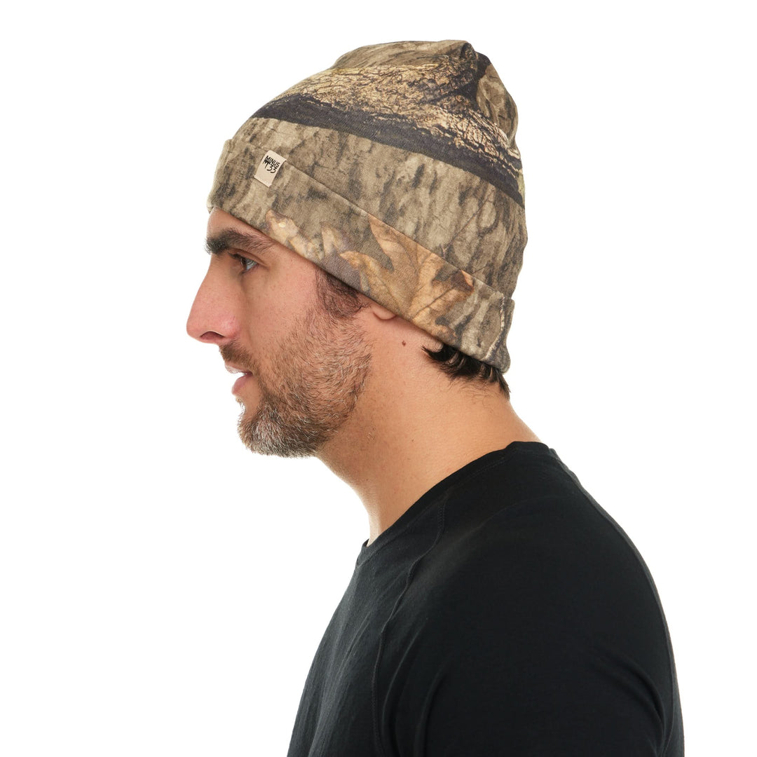 Camouflage merino wool beanie worn on a model, side view 