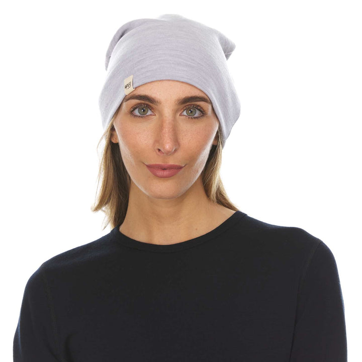 A woman models the lightweight, double-layered, hundred percent, super soft merino wool beanie perfect for fall, winter, and spring. This hat is perfect for a hike up the mountain or a walk around the block!
