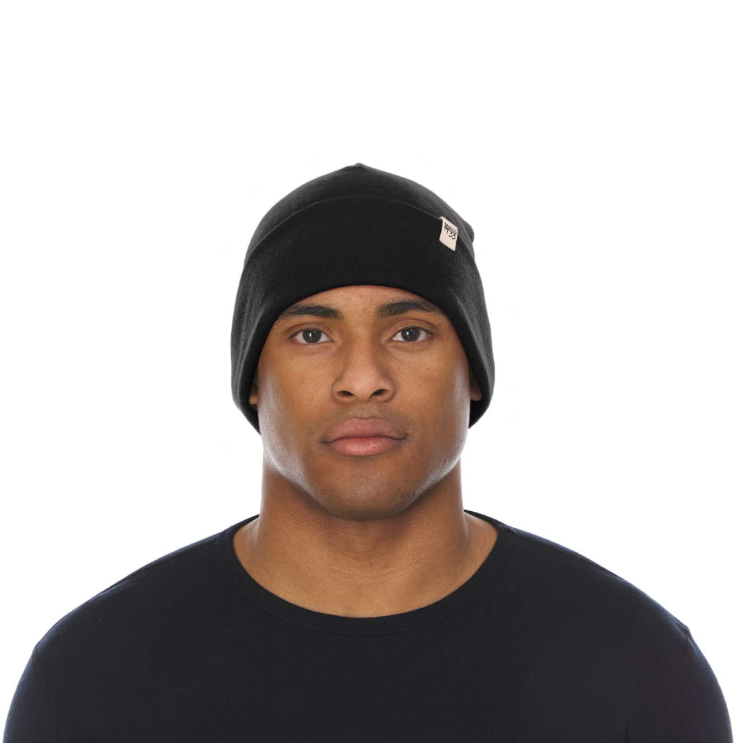 A man models the lightweight, double-layered, hundred percent, super soft merino wool beanie perfect for fall, winter, and spring. This hat is perfect for a hike up the mountain or a walk around the block!
