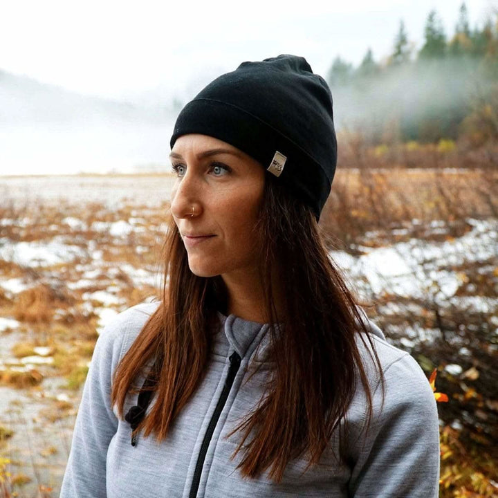 A woman models the lightweight, double-layered, hundred percent, super soft merino wool beanie perfect for fall, winter, and spring. This hat is perfect for a hike up the mountain or a walk around the block!

