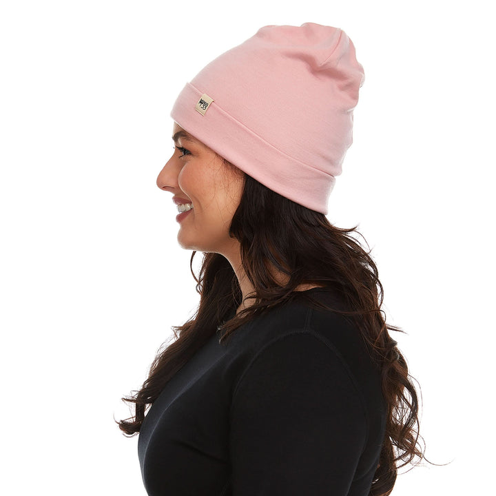 A woman models a lightweight, double-layered, hundred percent, super soft merino wool beanie perfect for fall, winter, and spring. This hat is perfect for a hike up the mountain or a walk around the block!
