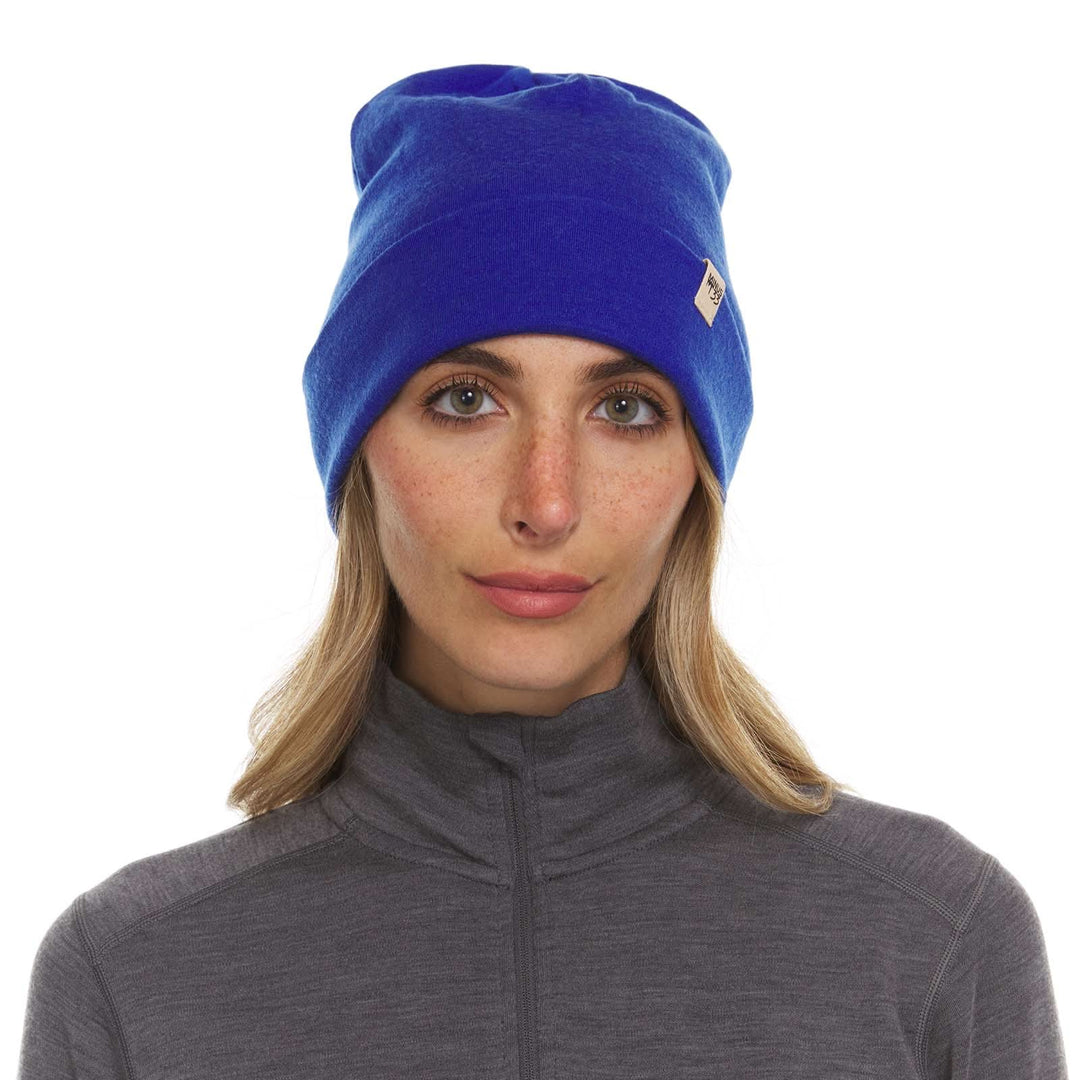 A woman models the lightweight, double-layered, hundred percent, super soft merino wool beanie perfect for fall, winter, and spring. This hat is perfect for a hike up the mountain or a walk around the block!
