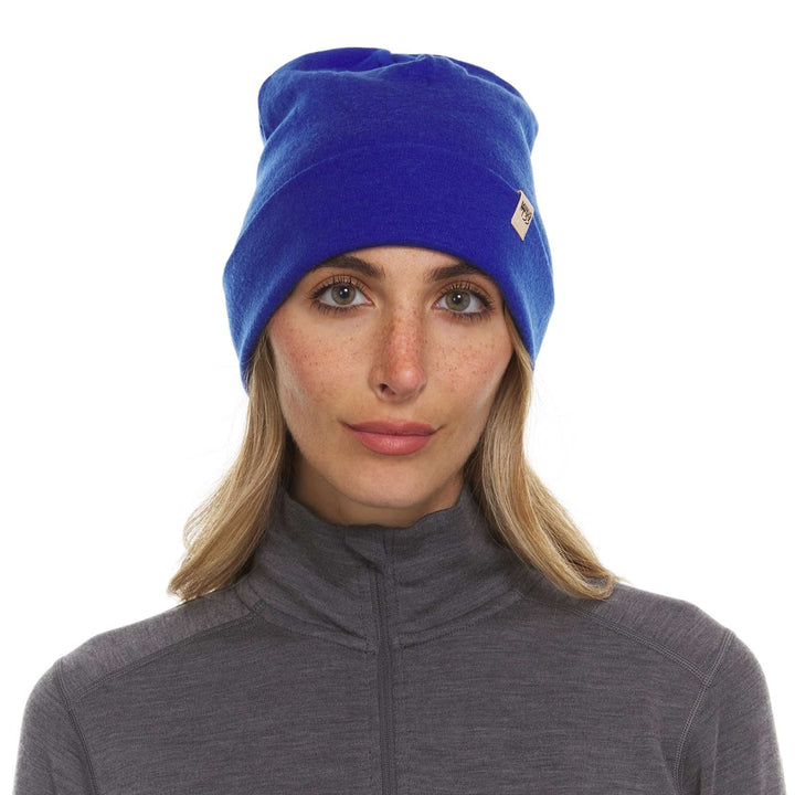 A woman models the lightweight, double-layered, hundred percent, super soft merino wool beanie perfect for fall, winter, and spring. This hat is perfect for a hike up the mountain or a walk around the block!
