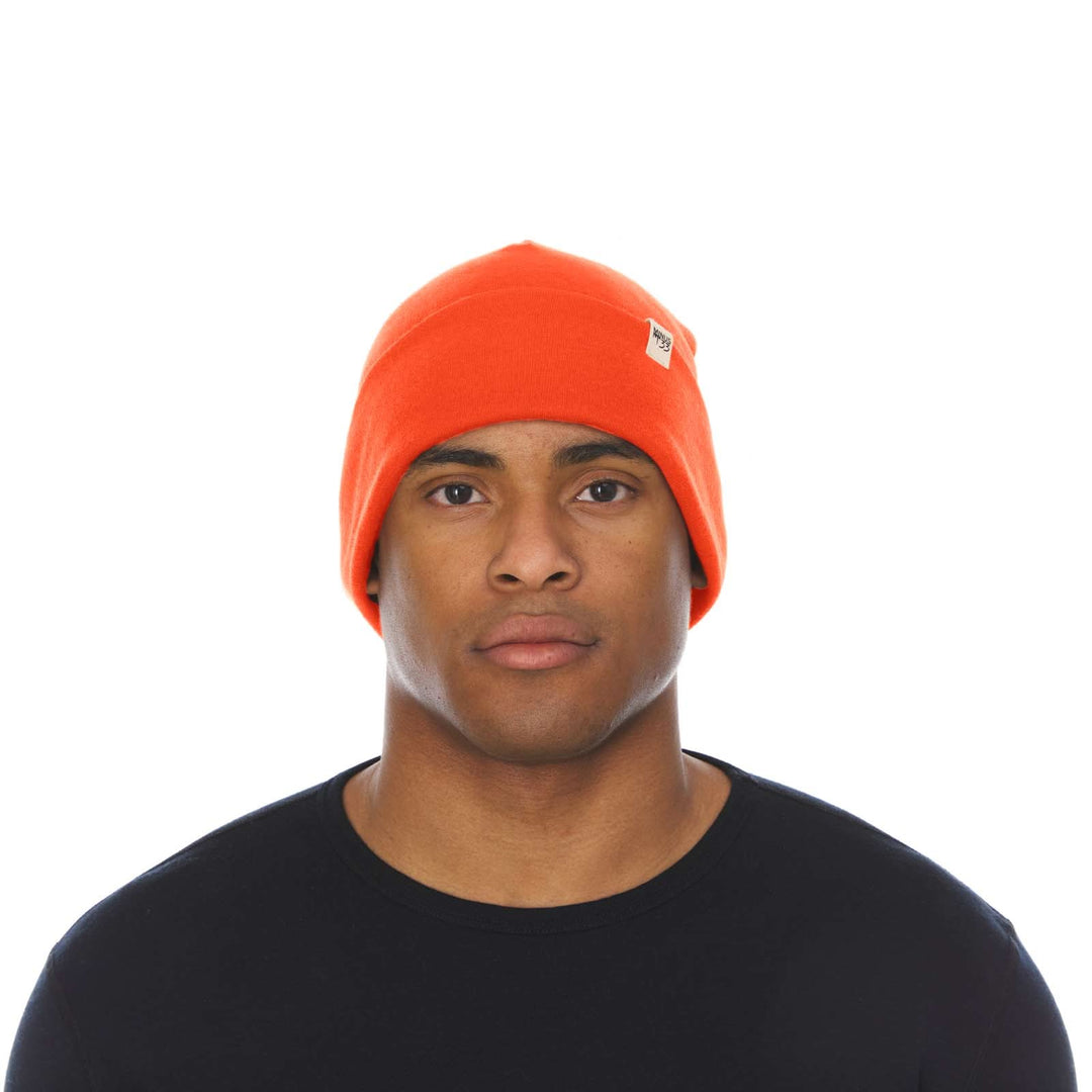 A man models the lightweight, double-layered, hundred percent, super soft merino wool beanie perfect for fall, winter, and spring. This hat is perfect for a hike up the mountain or a walk around the block, front view 