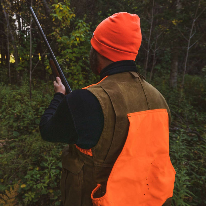 A hunter models the lightweight, double-layered, hundred percent, super soft merino wool beanie perfect for fall, winter, and spring. This hat is perfect for a hike up the mountain or a walk around the block!
