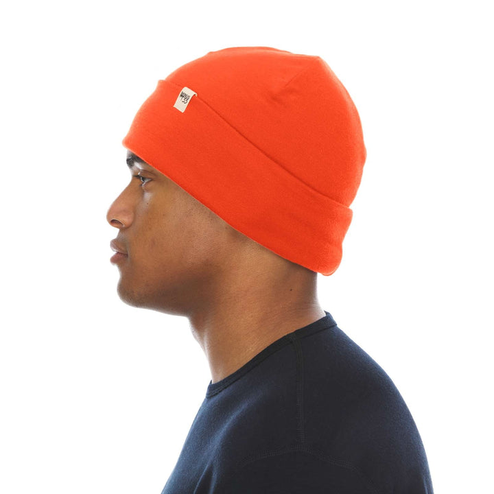 A man models the lightweight, double-layered, hundred percent, super soft merino wool beanie perfect for fall, winter, and spring. This hat is perfect for a hike up the mountain or a walk around the block, right-facing side view 