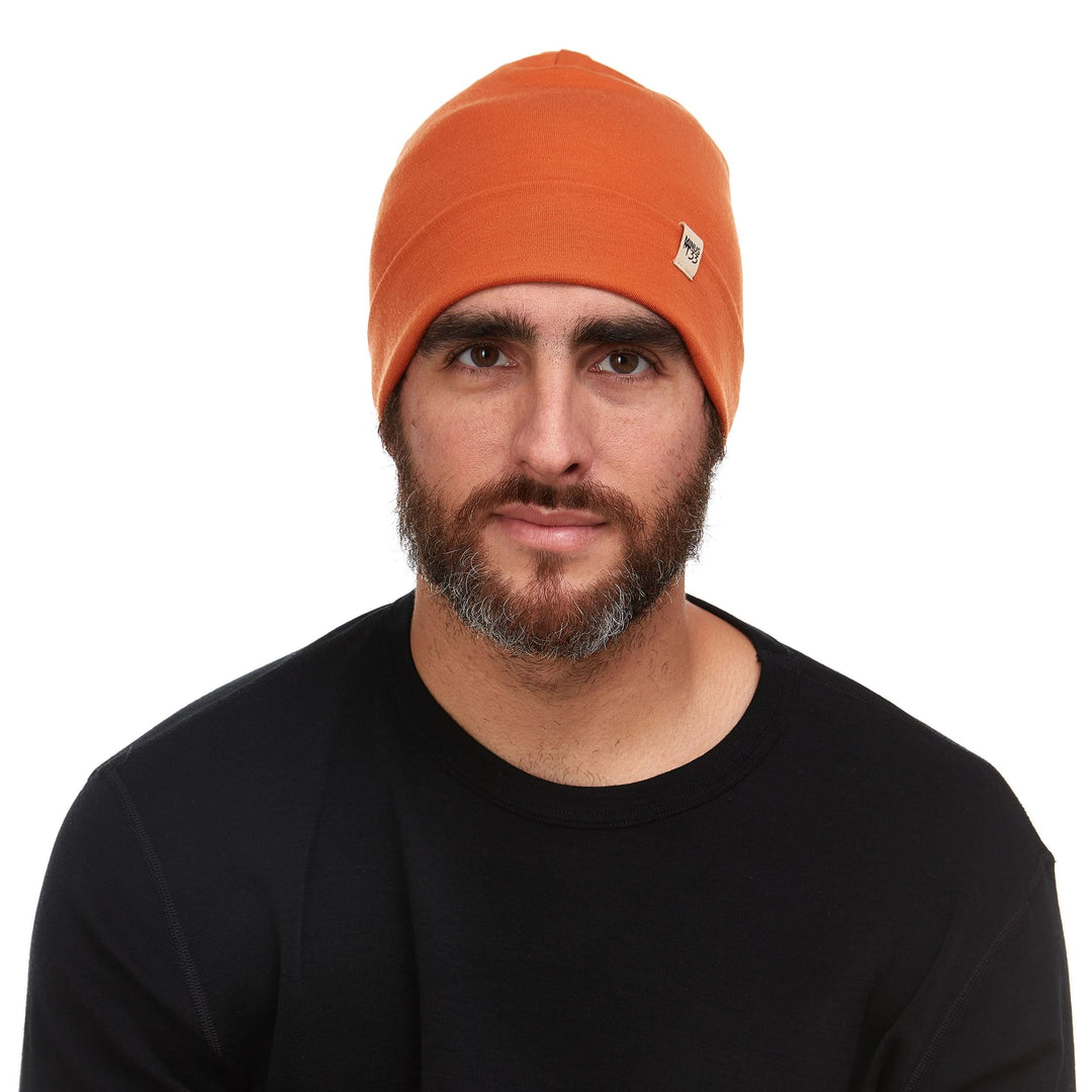 A man models the lightweight, double-layered, hundred percent, super soft merino wool beanie perfect for fall, winter, and spring. This hat is perfect for a hike up the mountain or a walk around the block!
