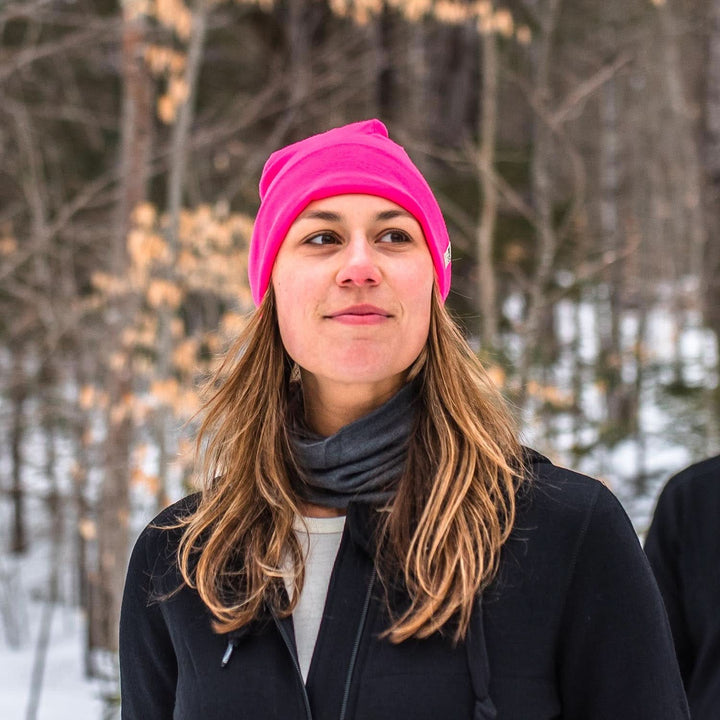 A woman on a snowy trail wears a lightweight, double-layered, hundred percent, super soft merino wool beanie perfect for fall, winter, and spring. This hat is perfect for a hike up the mountain or a walk around the block!
