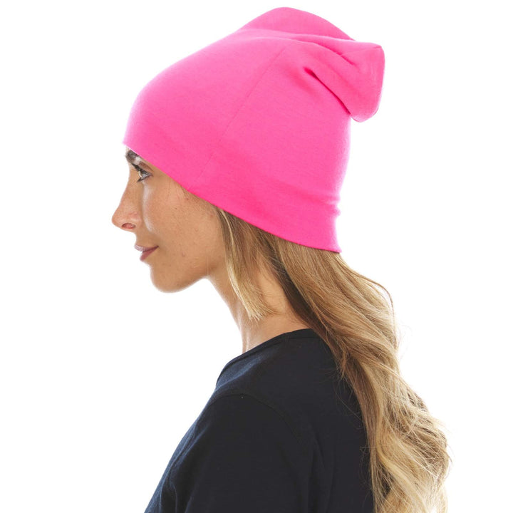 A woman models the lightweight, double-layered, hundred percent, super soft merino wool beanie perfect for fall, winter, and spring. This hat is perfect for a hike up the mountain or a walk around the block, right-facing side view 