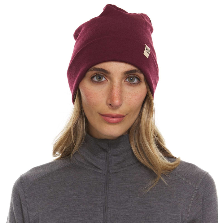 A woman models a lightweight, double-layered, hundred percent, super soft merino wool beanie perfect for fall, winter, and spring. This hat is perfect for a hike up the mountain or a walk around the block!
