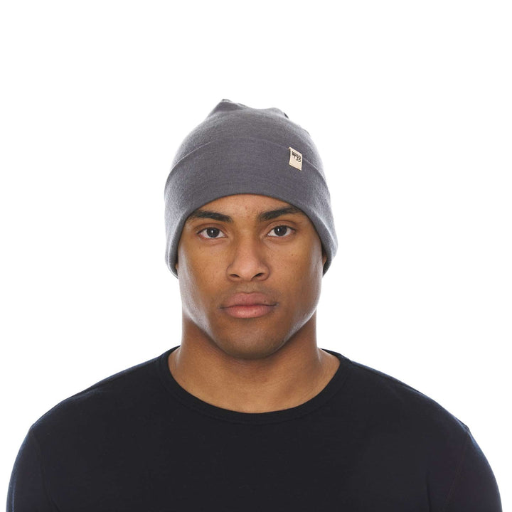 A man models the lightweight, double-layered, hundred percent, super soft merino wool beanie perfect for fall, winter, and spring. This hat is perfect for a hike up the mountain or a walk around the block!
