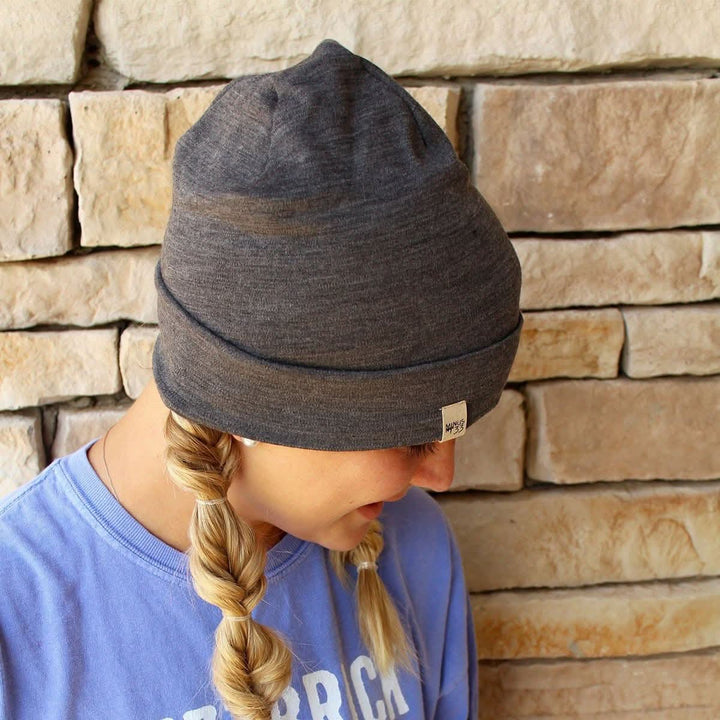 A woman models the lightweight, double-layered, hundred percent, super soft merino wool beanie perfect for fall, winter, and spring. This hat is perfect for a hike up the mountain or a walk around the block!
